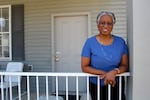 Annie Haigler poses on her front porch in the Park DuValle neighborhood of Louisville. Haigler says she wishes her neighborhood had more trees.