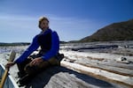 Charlie Crisafulli sits on the log mat at Spirit Lake, while doing research. The logs are the remnants of an old growth forest that was once on the slopes of Mount St. Helens.