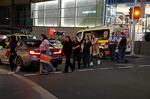 People are led out from the Westfield Shopping Centre where multiple people were stabbed in Sydney on Saturday.