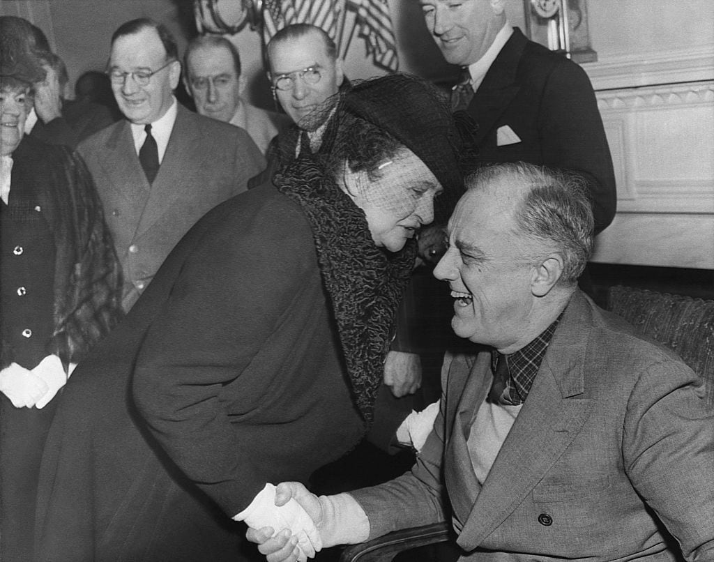 Frances Perkins is shown greeting President Franklin D. Roosevelt in 1943. Perkins was U.S. secretary of labor under Roosevelt from 1933 to 1945 and architect of the Social Security Act of 1935, which established federal support for elders, unemployed people, children and those who are blind.