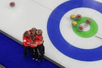 Canada's Rachel Homan, Tracy Fleury, Emma Miskew, and Sarah Wilkes celebrate after winning the women's curling bronze medal match against the United States at the 2026 Winter Olympics, in Cortina d'Ampezzo, Italy, Saturday, Feb. 21, 2026.
