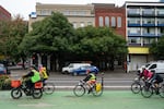 Commuters and Portland Bureau of Transportation volunteers ride on Southwest Naito Parkway.