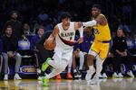 Portland Trail Blazers forward Deni Avdija (8) drives the ball against Los Angeles Lakers forward Rui Hachimura (28) during the second half of an NBA basketball game Monday, Oct. 27, 2025, in Los Angeles.