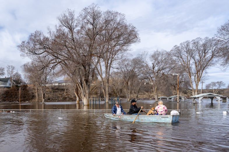 Area residents navigate the flooding near Triangle Park in Burns, Ore., March 30, 2025. 