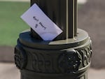 An envelope labeled "Rent Money" is left tucked in a lighting pole in Los Angeles on April 1. President Trump's new executive order to prevent evictions isn't enough and Congress needs to act, housing activists say.