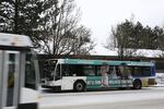 Trimet busses locked equipped with snow chains pick up commuters the morning after Portland's winter storm. 