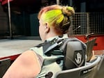 FILE - Becky Hatley, the Gesa Power House Theatre’s artistic director, demonstrates how to wear a haptic vest while sitting in an auditorium seat.