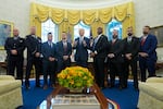 President Joe Biden, center, poses for a photo with Medal of Valor honorees in the Oval Office of the White House in Washington, Friday, Jan. 3, 2025. Honorees are, from left, Lt. John Vanderstar of the New York City Fire Department, Firefighter Brendan Gaffney of the New York City Fire Department, Sgt. Tu Tran, of the Lincoln, Neb. Police Department, Det. Michael Collazo, of the Nashville, Tenn. Police Department, Chief John Drake, receiving on behalf of Officer Rex Engelbert, of the Nashville, Tenn. Police Department, Sgt. Jeffrey Mathes, of the Nashville, Tenn. Police Department, Det. Zachary Plese, of the Nashville, Tenn. Police Department, and Det. Ryan Cagle, of the Nashville, Tenn. Police Department.