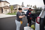 Andrés Portela III and wife, Angelina, ready their car before the drive back to Arizona from Bend, Ore., on Aug. 28, 2025.