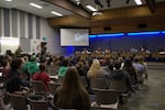 Families and workers fill a Eugene 4J School Board meeting in Eugene, Ore., Dec. 10, 2025.