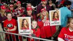 Supporters of former president and 2024 presidential hopeful Donald Trump hold images of Laken Riley before he speaks at a "Get Out the Vote" rally in Rome, Ga., on March 9, 2024.