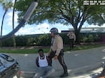 This screen capture from bodycam footage of Miami-Dade Police shows an officer detaining Miami Dolphins player Tyreek Hill following a traffic stop on Sunday.