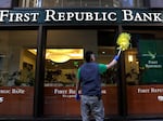 A worker cleans the outside of a First Republic bank in San Francisco.