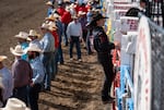 Saddle bronc competitor Wyatt Casper of Texas, climbs over the chutes before his event on Friday.