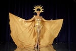 Miss South Africa, Chedino Rodriguez Martin, poses in her national costume. The costume, a golden body suit with a sun crown and cape, paid homage to South Africa's illegal mine workers.
