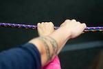 Grand Ronde tribal community members hold onto a pair of climbing ropes as part of a group exercise.