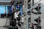 Artificial Intelligence robots demonstrate working on power grid control units during a media organized tour at Guangdong Power Grid Robotics Laboratory in Guangzhou, in southern China's Guangdong province, on April 16.