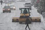 A plow clears a parking lot during a winter storm on Sunday in Cincinnati.