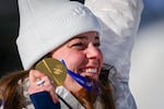 American skier Breezy Johnson holds up her gold medal on the podium of the women's downhill event during the Milano Cortina 2026 Winter Olympic Games at the Tofane Alpine Skiing Centre in Cortina d'Ampezzo on Feb. 8.