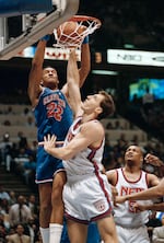 Cleveland Cavaliers Larry Nance (22) stuffs the ball over New Jersey Nets Chris Dudley in the third period of their Eastern Conference playoff game at the Meadowlands Arena, Thursday, May 1, 1992, East Rutherford, N.J. The Cavaliers went on to win the game 98-89 to advance in the playoff Series.