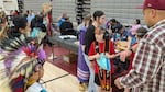 Nakotah Reynolds, 11, wears headphones to reduce his overstimulation as he hands out gift bags to dancers who participated in the special his family organized on Sept. 26, 2026. It’s common practice for
the sponsors of a special to give gifts to participants after the dance.