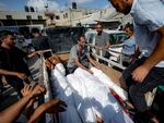 Palestinians gather near the bodies of their relatives killed in the Israeli bombardment of the Gaza Strip, at a hospital morgue in Deir al-Balah, on Saturday.