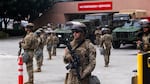 National Guard troops stand outside the Metropolitan Detention Center on Sunday in Los Angeles. Tensions in the city remain high after the Trump administration called in the National Guard against the wishes of city leaders following two days of clashes with police during a series of immigration raids.