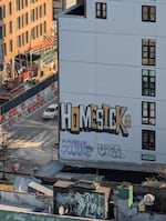 Homesick tagged on a SoHo building alongside street construction