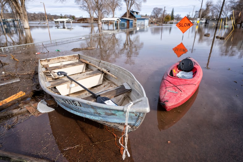 Kayaks and small boats are used by locals to save what they can in the North Broadway Avenue area in Burns, Ore., March 30, 2025. 