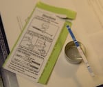 A package of fentanyl test strips, with one having found no fentanyl in a sample. 