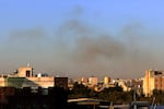 Smoke rises from the area around Yemen's Sanaa International Airport following an airstrike on Thursday. The Israeli military reported targeting infrastructure used by the Houthis at the airport, as well as a number of ports and power stations.