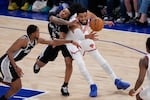 New York Knicks center Karl-Anthony Towns, right, and San Antonio Spurs guard Stephon Castle (5) battle for the ball during the second half of Game 4 of the NBA Finals basketball series, Wednesday, June 10, 2026, in New York.