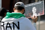 A man holds a sign supporting 2023 Nobel Peace Prize winner Narges Mohammedi, imprisoned in Iran for many years. A few demonstrators gathered at Portland's waterfront on March 7, 2026, to oppose the regime of the Islamic Republic of Iran. 