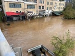 The River Arts District in Asheville, N.C., during the flooding from Tropical Storm Helene in 2024. The French Broad River crested high enough to breach the first floor of the buildings.
