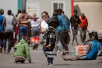 A member of the emergency services carries a little child, part of a group of 175 migrant people who arrived on board a boat, at Restinga port on the Canary island of El Hierro on August 18, 2024.