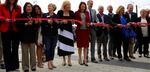 Vancouver leaders line up alongside state and federal representatives to cut the ribbon at the Vancouver Waterfront grand opening.