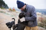 Thad McCracken hugs his dog Wyatt after a 12-mile run.