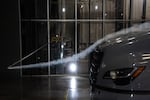 Smoke shows fast-moving wind going over the hood of a semi-truck in a wind tunnel.