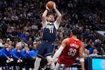 Dallas Mavericks guard Luka Doncic (77) shoots against Portland Trail Blazers forward Toumani Camara (33) during the second half of an NBA basketball game, Monday, Dec. 23, 2024, in Dallas.