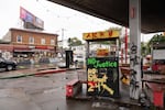Graffiti condemning the police and demanding racial justice cover defunct gas pumps at George Floyd Square.