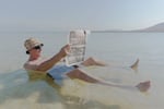 Gregory, a recent immigrant from Russia, floats in the Dead Sea at a beach connected to an Israeli hotel resort on Nov. 10. The water of the lake is so full of salt that bathers float right to the top.