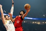 Portland Trail Blazers guard Shaedon Sharpe, right, drives to the hoop against Utah Jazz center Walker Kessler, left, during the first half of an NBA basketball game Thursday, Dec. 26, 2024, in Portland, Ore.