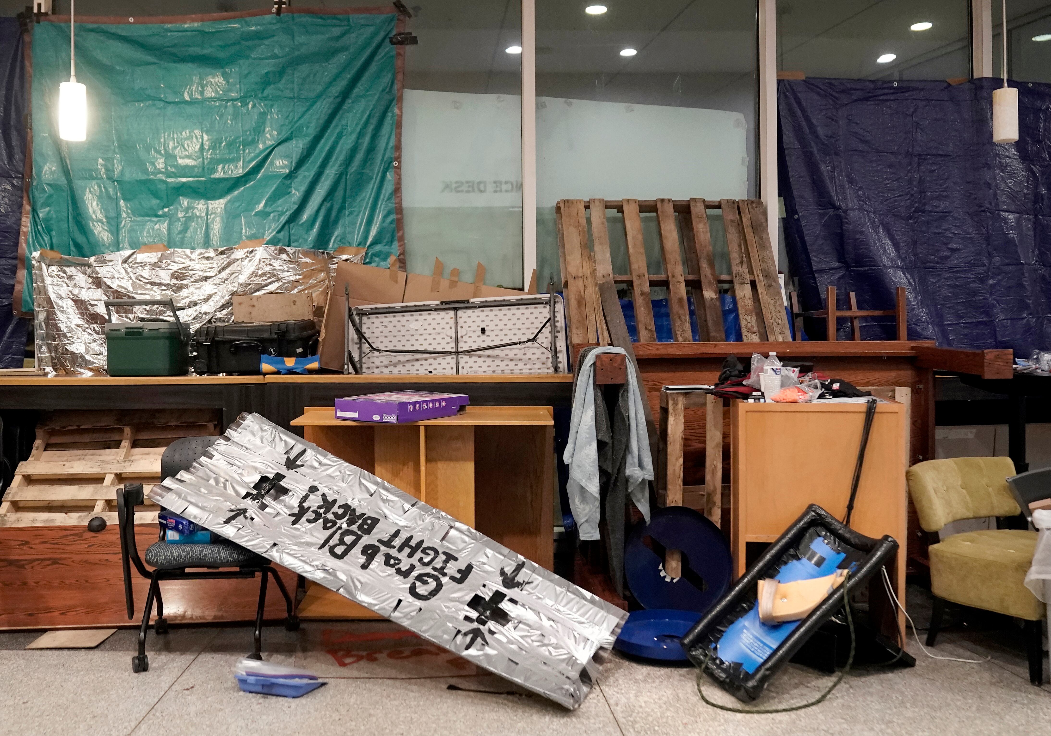 Defense items and barricades on the first floor, near the main entrance of the library.