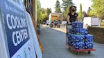 A volunteer helps set up snacks at a cooling center established in Multnomah County last summer on Aug. 11, 2021 to help vulnerable residents ride out the second dangerous heat wave to grip the Pacific Northwest.