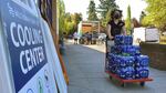 A volunteer helps set up snacks at a cooling center established in Multnomah County last summer on Aug. 11, 2021 to help vulnerable residents ride out the second dangerous heat wave to grip the Pacific Northwest.