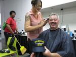 Donald Reed Powers gets a free hair cut at the Stand Down event for veterans.