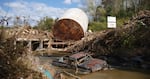 A truck is stuck in water and mud following flooding from Hurricane Helene in western North Carolina.