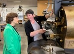 Emily Smith of Hacea Coffee Source shows U.S. Rep. Suzanne Bonamici, D-Beaverton, coffee roasting equipment during a tour of Southeast Portland’s Buckman Coffee Factory On May 29, 2025. Smith says import tariffs are forcing Hacea to pass some higher costs on to customers.