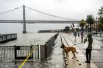 Water from the San Francisco Bay spills onto the Embarcadero in San Francisco on Saturday, Dec. 14, 2024, as a result of high tides and storm-driven waves.