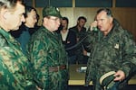 Bosnian Serb Gen. Ratko Mladic (right) talks on the phone next to Russian Army Gen. Vladimir Zurbenko (center) during the visit of a Russian Army delegation to the Bosnian town of Banja Luka in October 1995.